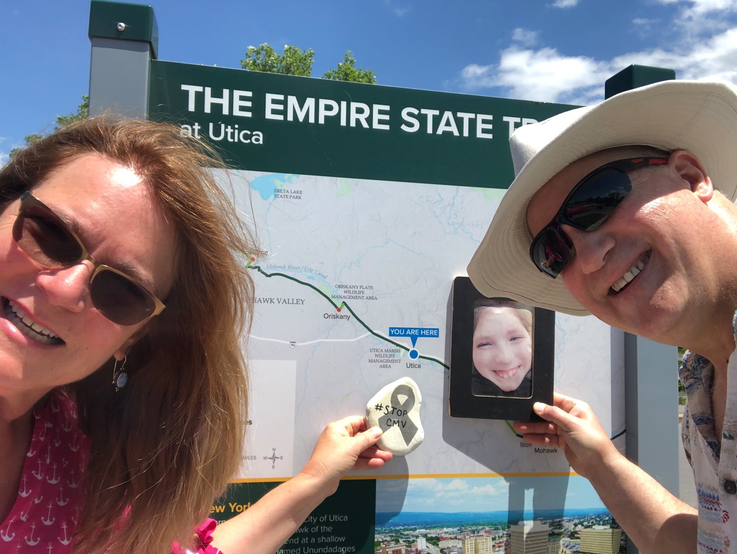 Taking selfies at mile markers, Lisa and Jim Saunders memorialize their journey and their quest to walk across New York State on the 360-mile Erie Canalway Trail. to raise awareness of CMV. Leaving silver painted rocks, #StopCMV, as of November, the couple has clocked in 189 miles. or 53 percent of their goal.